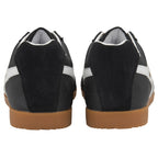 Pair of black sneakers with white stripes and brown soles, rear view