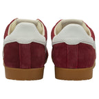 Pair of red suede sneakers with white heel tabs and gum soles, rear view