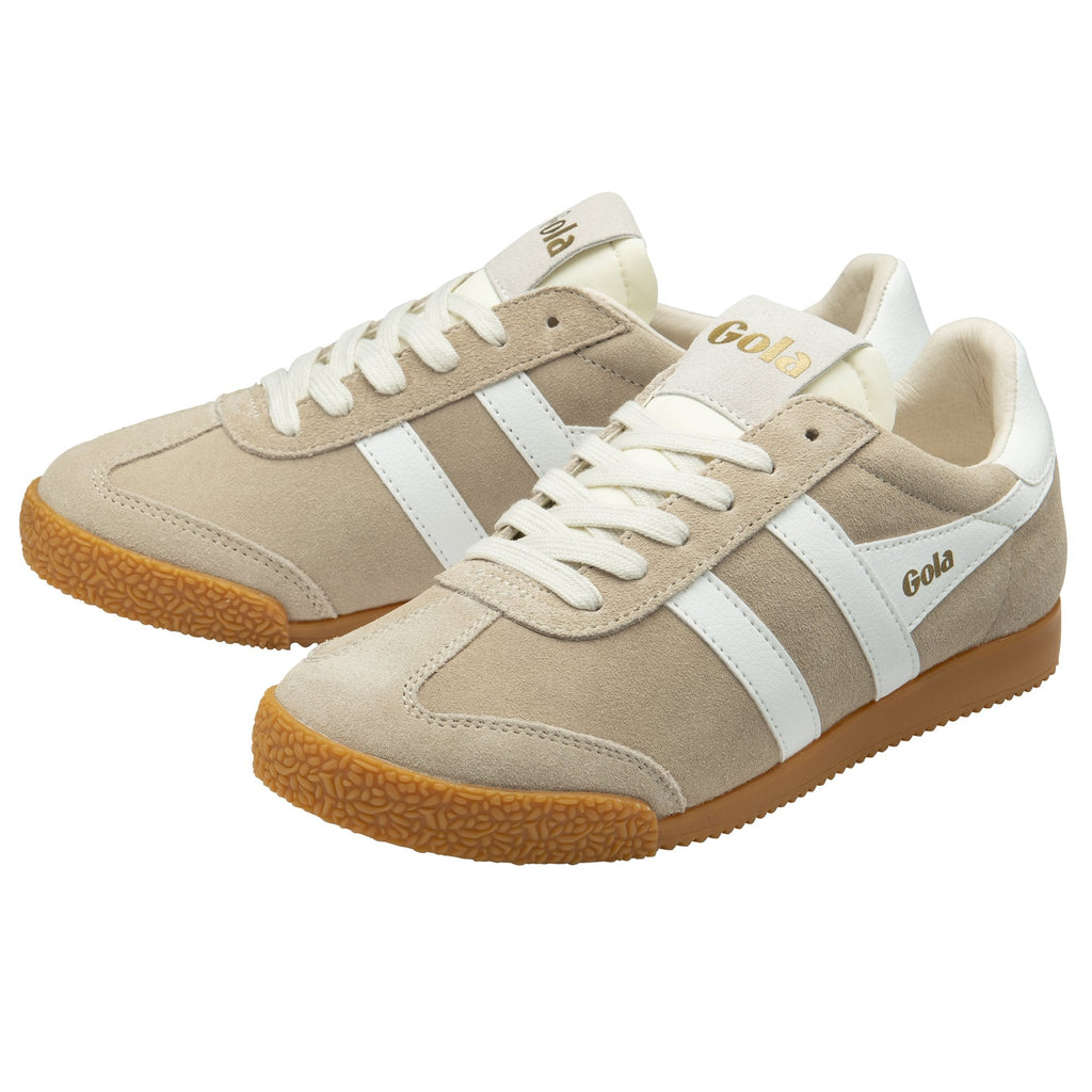 A pair of Gola Harrier trainers in off-white with white stripes, angled left.