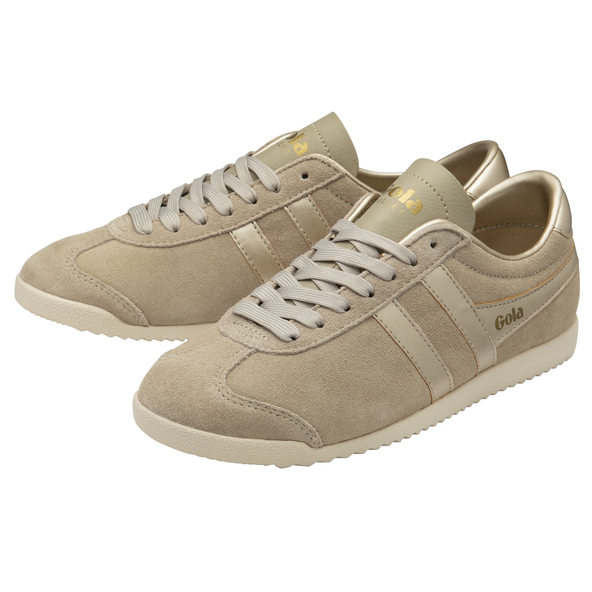 A pair of Gola Hurricane trainers in light brown suede with gold accents, angled.