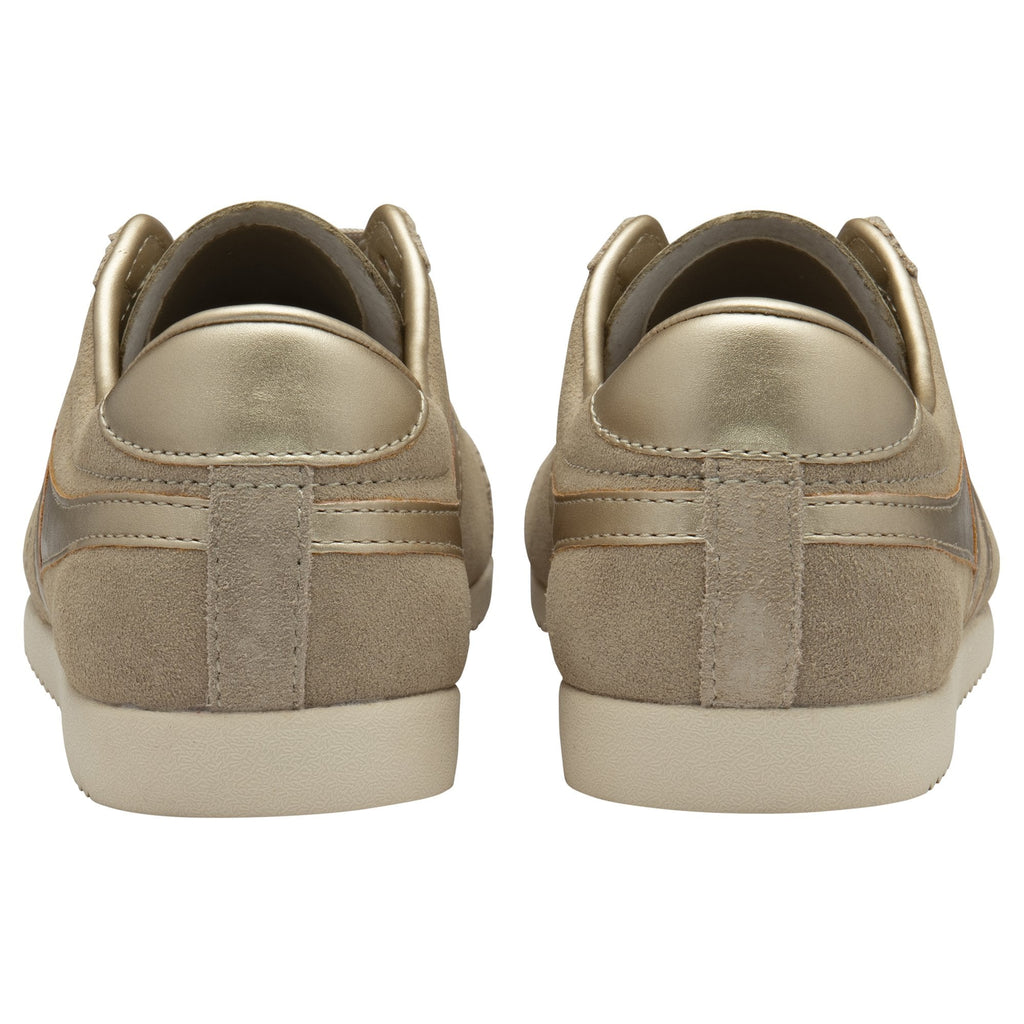 The rear view of a pair of Gola Hurricane trainers in light brown with gold heels.