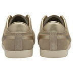 The rear view of a pair of Gola Hurricane trainers in light brown with gold heels.