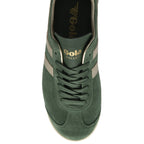 Top-down view of a green Gola trainer, showcasing the laces, gold stripes, and branding.