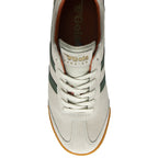 Overhead view of a Gola Harrier trainer in off-white suede with dark green stripes and a gum sole