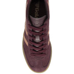 The top-down view of a single burgundy Gola sneaker with tan stripes and laces.