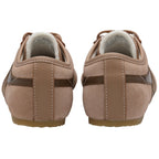 Rear view of two light brown suede sneakers with dark brown stripes and white faux fur lining.