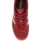 Top down view of a red suede Gola trainer with white stripes and a gum sole