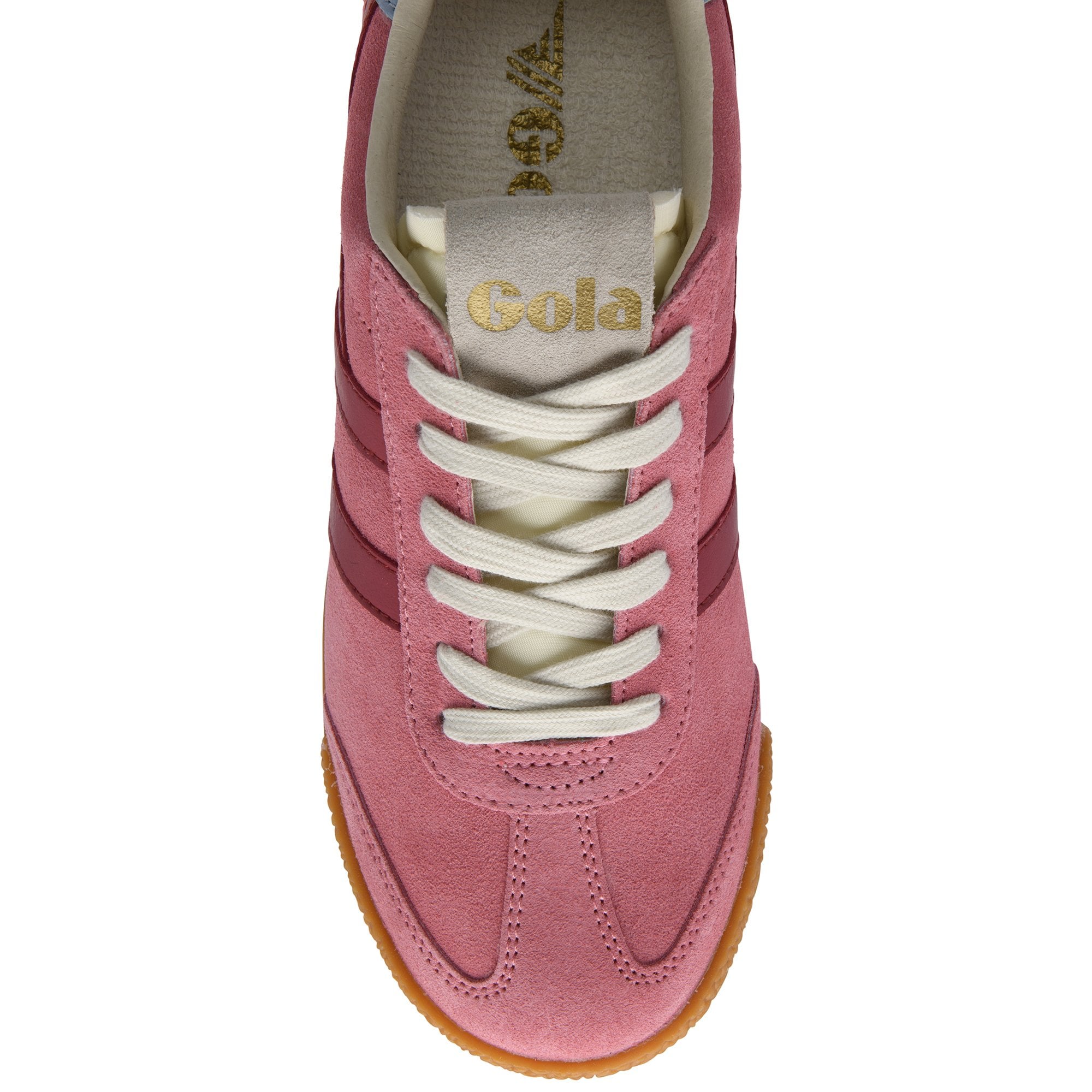 Close up of a pink suede trainer with white laces and a gum sole